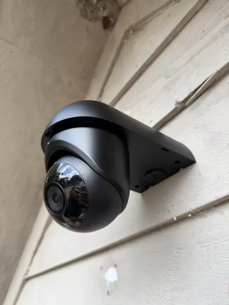 Turret surveillance camera on a wall-mount bracket
