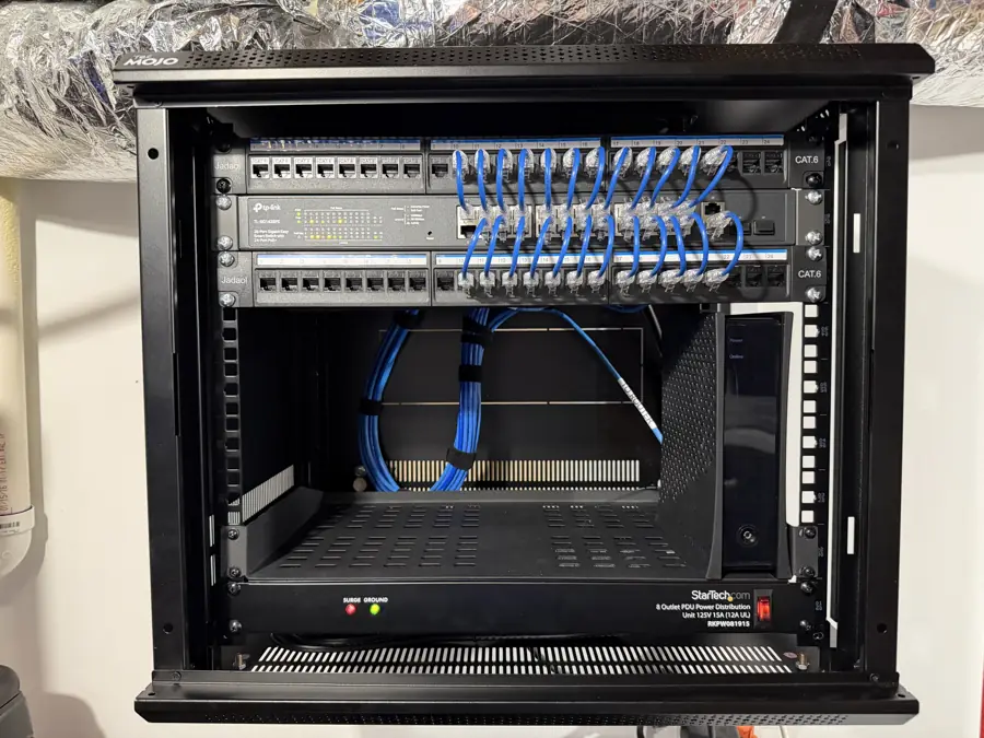 Clean wall-mounted network rack with patch panel and switch